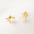 Pair of gold earrings with pearls on a white background