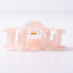Small pink hair clip on a light background