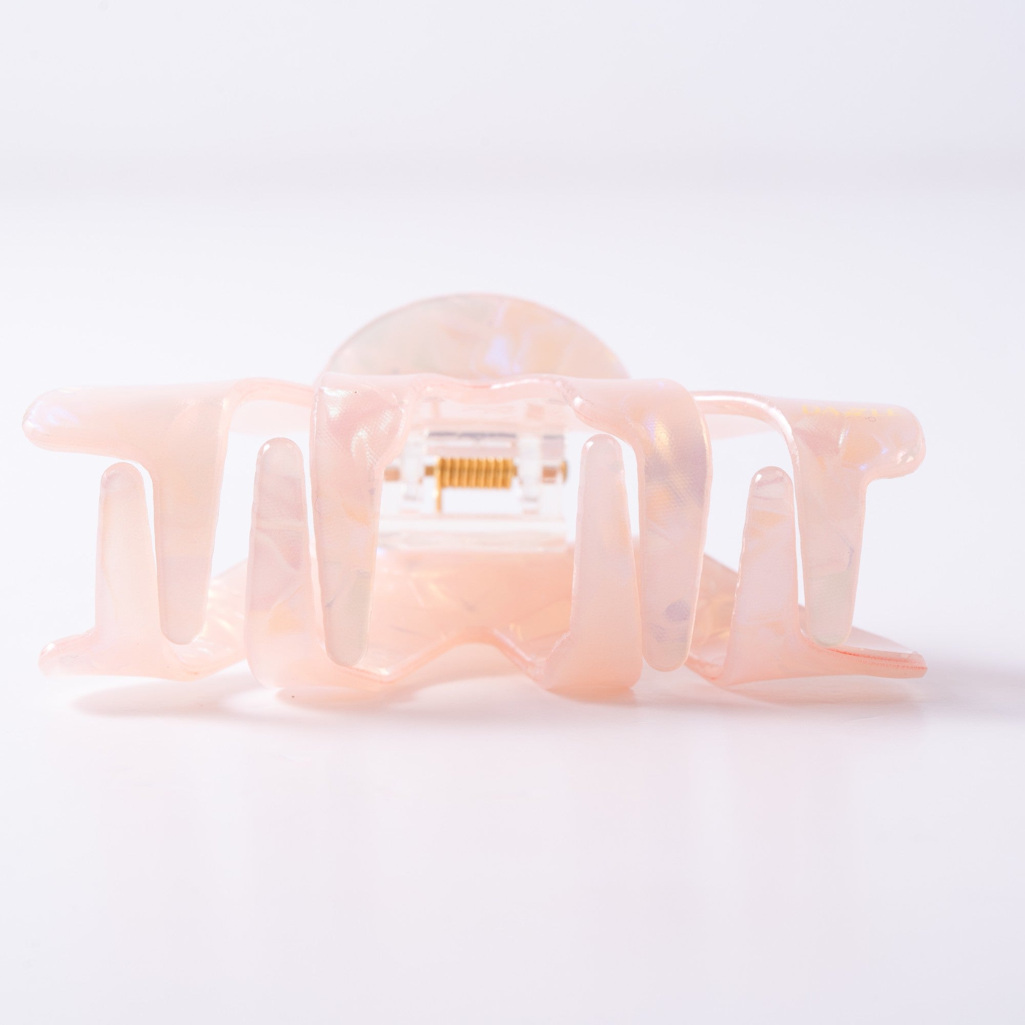 Small pink hair clip on a light background